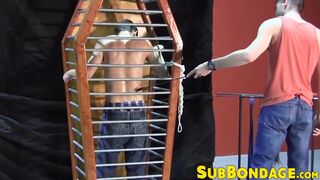 BDSM fun with a dude trapped in a cage by his master